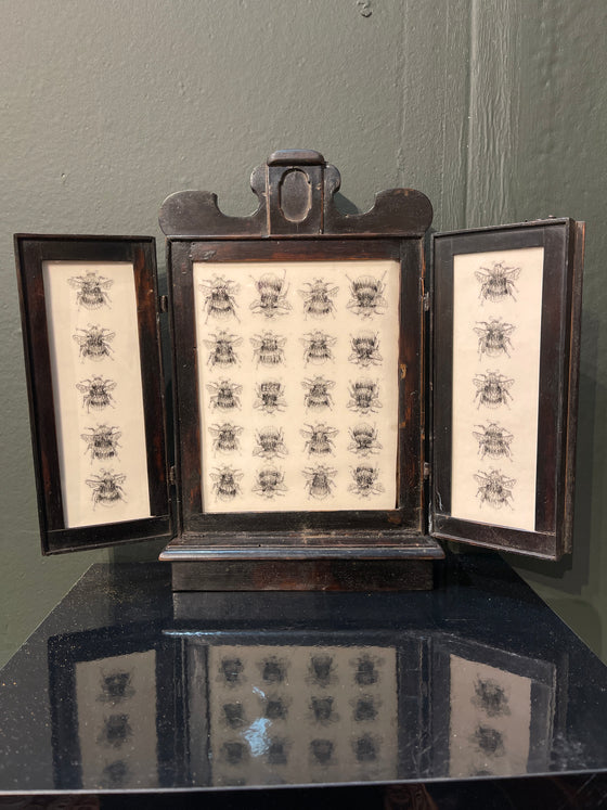 Bee columns, in a 19th century ebonised triptych